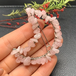 Close-up of crescent moon hair clip crafted with pink crystal stones and wire wrapping