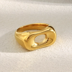 Macro shot of gold-plated stainless steel hollow ring with polished mirror finish