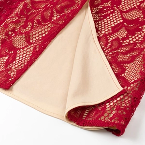 Macro shot of burgundy lace texture and beige lining on long sleeve dress