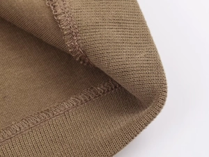 Detail of ribbed knit cuffs and hem on a brown stylish lounge set for women