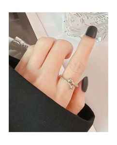 Close-up of silver wraparound heart ring with cubic zirconia stones on hand