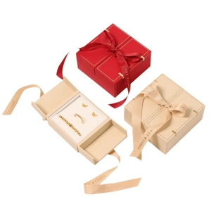Elegant red and beige jewelry gift boxes with ribbons for rings, earrings and necklaces