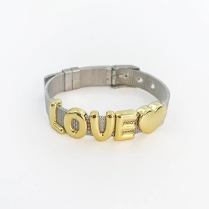 Detail of Milanese mesh bracelet showing gold LOVE letters and heart charm