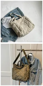 Detail of quilted cotton tote bag with side pockets and adjustable strap for daily use