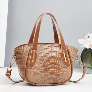 Brown crocodile embossed handbag with gold hardware and a detachable shoulder strap