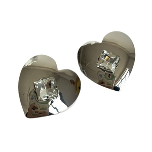 Polished silver heart earrings featuring a claw-set square cubic zirconia on white background