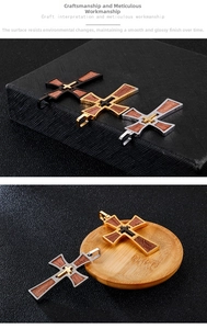 Detail of cross pendants with stainless steel frames and walnut wood inlays in three colors