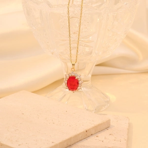 Golden stainless steel necklace with red egg-shaped crystal pendant and pavé rhinestones