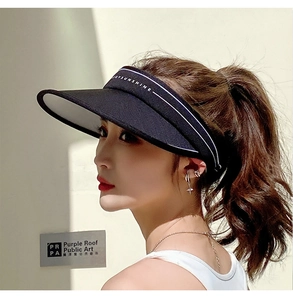 Detail of JOYSUNSHINE text on a black wide-brim sun hat with white stripe accents