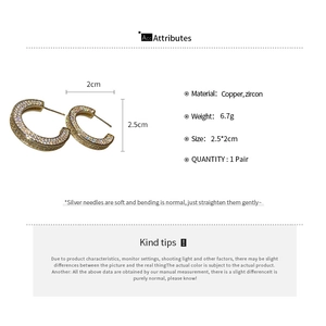 Detailed spec view of C-shaped gold earrings with white zircon stones and dimensions