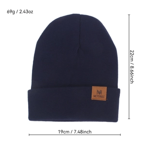 Warm navy blue knit beanie hat with leather patch detail for winter fashion style