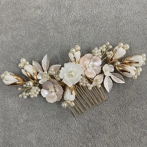 Golden bridal hair comb with cream ceramic flowers and pearls for wedding hairstyles