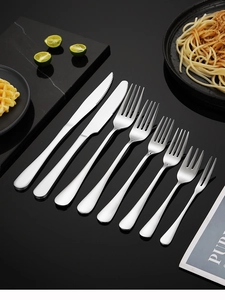 Close-up of 304 stainless steel cutlery set arranged on a modern dining tabletop