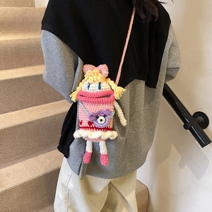Handmade crochet girl's crossbody bag with funny doll design and pink knit texture
