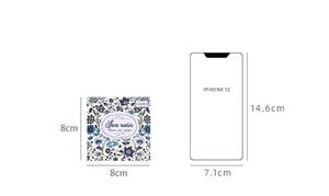 Size comparison of 8x8cm blue floral scrapbooking paper next to an iPhone 12