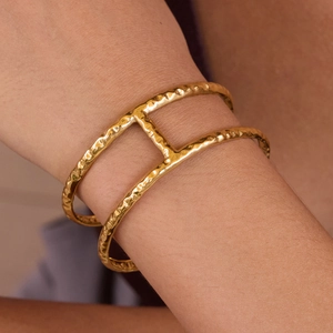 Detailed view of 18K gold plated stainless steel double-layered hammered cuff bracelet
