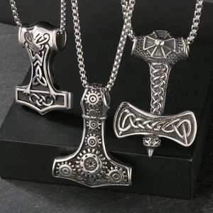 Macro view of three Thor's hammer Mjolnir pendants with Celtic and steampunk patterns