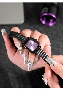 Detail of square purple sunray dial watch with black metal elastic strap in hand