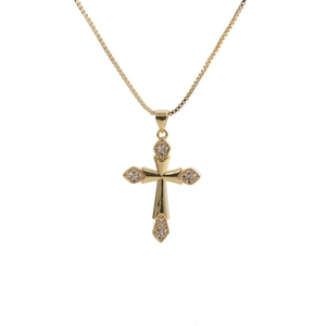 Detailed view of a gold cross pendant necklace featuring shimmering white cubic zirconia