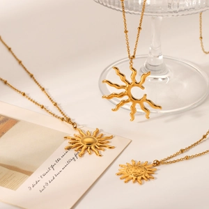 Detailed view of three gold sun and starburst pendants with premium metallic luster