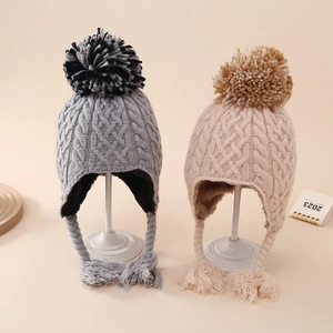 Winter baby knit earflap hat with thick cable stitch and fluffy pompom for toddlers
