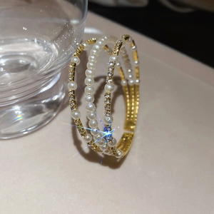 Detail of multi-layer gold pearl bangle with sparkling rhinestones and crystal accents