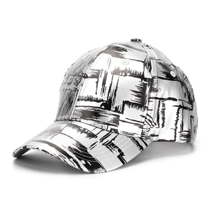 Detail of silver metallic PU baseball cap featuring black and white graffiti print patterns