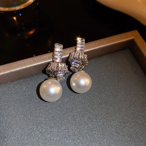 Elegant knot-design silver stud earrings with sparkling cubic zirconia and white pearls