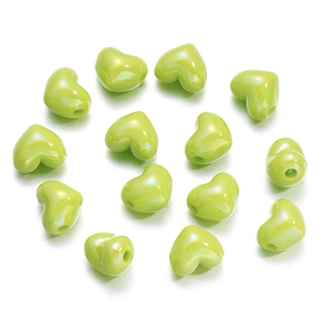 Close-up of glossy green heart-shaped resin beads arranged in a circular DIY pattern