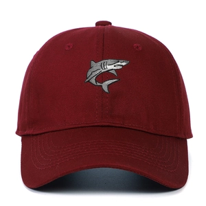 Close-up of gray 3D shark embroidery on a wine red cotton twill baseball cap
