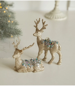 Close-up of golden glitter reindeer statues with colorful sequins for Christmas decor