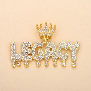 Close-up of gold plated dripping LEGACY pendant with crown and clear rhinestones