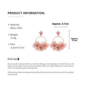 Detail view of pink cloth flower earrings with alloy metal rings and size measurements