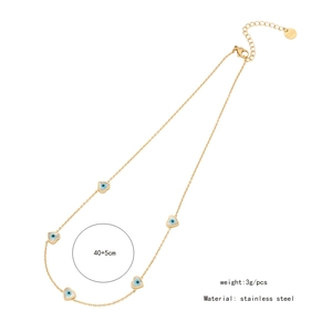 Detail of gold stainless steel necklace with five blue evil eye heart pendants