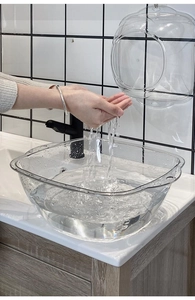 Close-up of deep transparent washbasin showing large capacity and splash-proof design