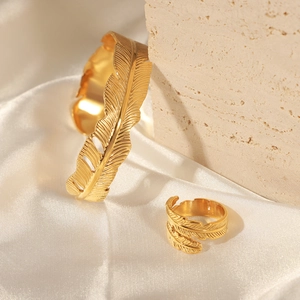 Golden feather design jewelry set including adjustable open cuff bangle and matching ring