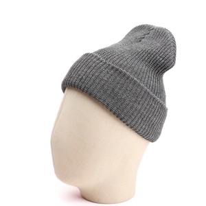Detail of dark grey knit beanie featuring a thick ribbed texture and wide cuffed brim
