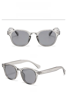 Détail de lunettes de soleil gris transparent avec rivets et verres gris haute définition