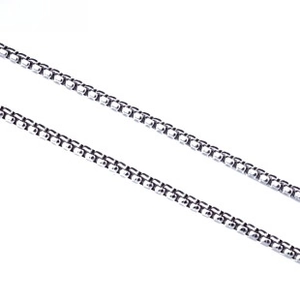 Macro detail of silver box chain showing square links and polished metal finish