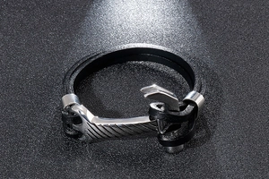 Detail of multi-layer braided leather bracelet with silver hammer-style clasp for men