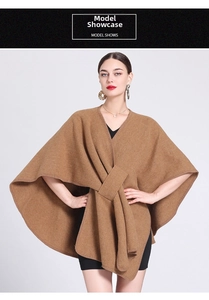 Detail view of the elegant brown knit poncho with a V-neck and draped crossover design