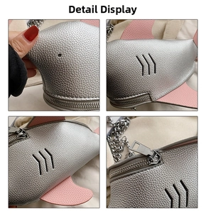 Close-up of silver shark crossbody bag with pink fins and lychee texture detail