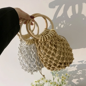 Detail of handmade woven straw bags with wooden handles and cotton inner pouch