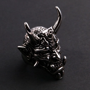 Macro side view of a detailed stainless steel Hannya mask ring with a vintage silver finish