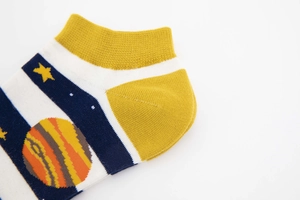 Detailed macro view of cotton ankle socks with planet patterns and yellow reinforced heel