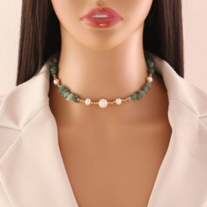 Close-up of a model wearing the natural green stone and pearl necklace on the neck
