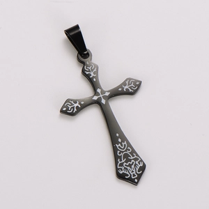 Macro view of black stainless steel cross pendant with detailed laser-engraved patterns