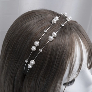 Elegant double-layered silver headband with delicate pearls and rhinestones on a mannequin