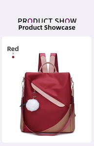 Detail of red and beige waterproof nylon backpack with white pom-pom keychain