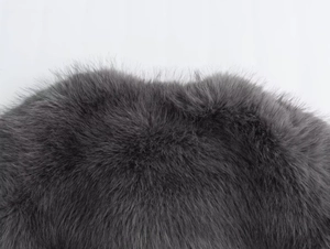 Detailed close-up showing the soft texture of grey faux fur fabric for jackets